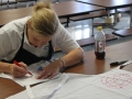 The women who work in the cafeteria decorated their white aprons.