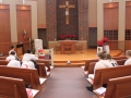 Students in white take time out of their day to pray for Jablonski in the chapel.
