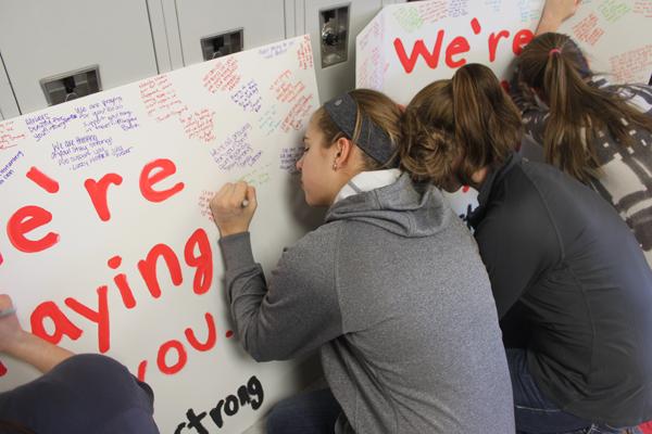 Students sign sympathy cards for Wayzata players