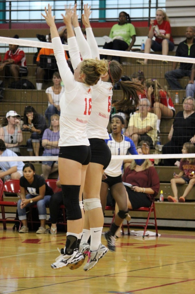 Two girls volleyball players set up to block a play by the Hopkins Royals in their first home game on September 10. 