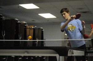 Varsity player Danny Hogan practices his ping-pong skills during practice against other BSM students.