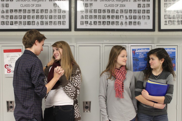 Innocent bystanders must uncomfortably wait for a PDA-ing couple to pass before getting to their locker.