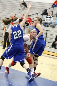 Junior captain Grace Coughlin fights through two Minnetonka players. (carson mark)