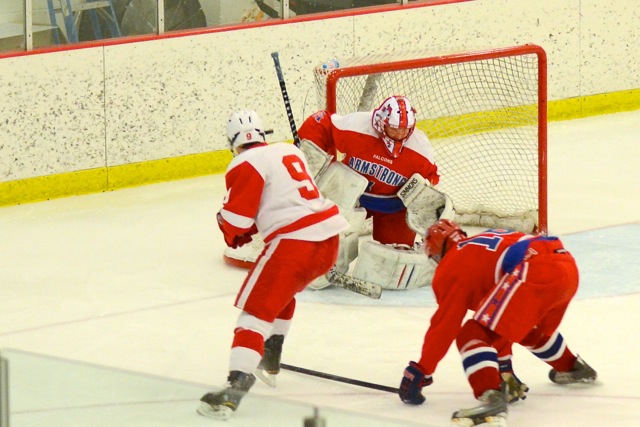 Junior Zack Hale tries to put the puck past the Armstrong goalie in the Section Quarterfinal game. 
