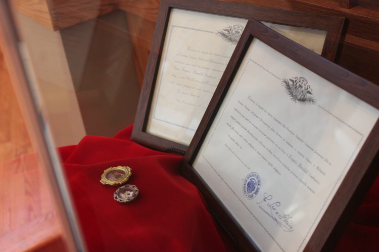 A bone fragment is placed in the Chapel of St. Benilde with certificates of authenticity. 