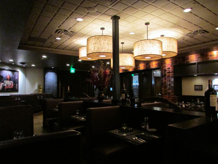 The restaurant's interior uses dark colors to create a modern atmosphere. 
