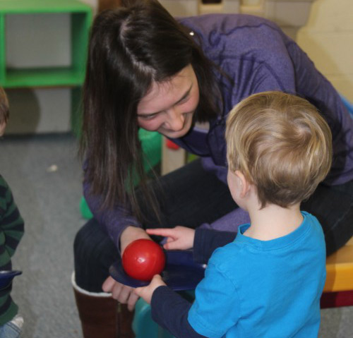 Senior Zoe Cave, one of three students who volunteer weekly with the Little Knights, plays with the kids, helps set up activities, helps clean up and forms close relationships with each of them.