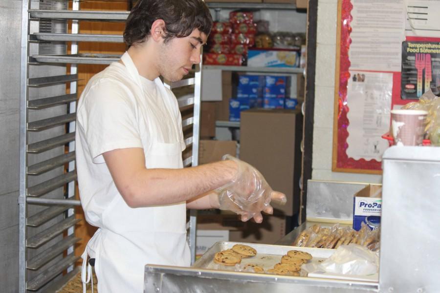 Junior Sam Lobash assists Taher with cookie production in the BSM kitchen. Lobash has also worked as a cook at several restaurants in the metro area, and he hopes to continue this work through the next several years to gain experience.