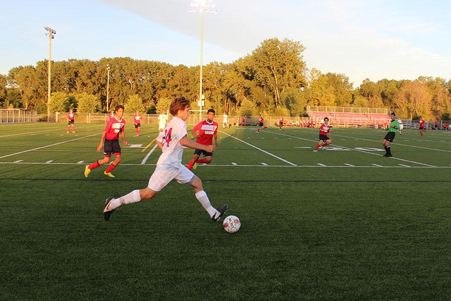 Junior Griffin Ehlen looks to find a teammate in an early season match against Orono. 