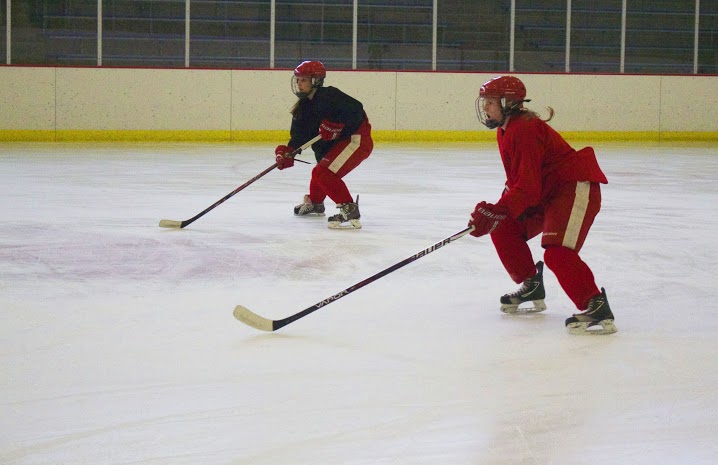 Two defensemen at work in their first practice of the season, preparing for the long road to the State tournament.