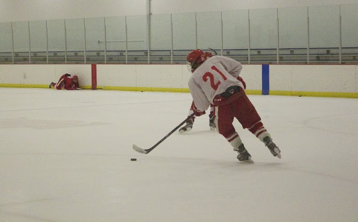 Junior Jacob Holmers moves the puck up the ice during tryouts. 