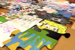 Puzzle pieces’ mediums varied from acrylic paint to markers, photos, fabric, or a combination of materials.
