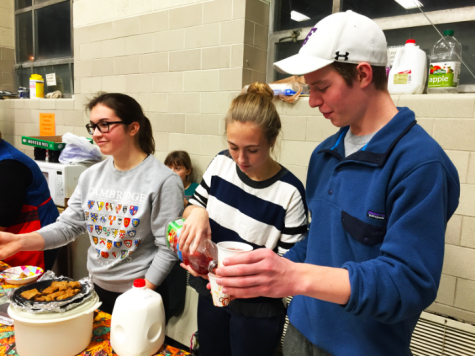 Juniors Macy Rooney, Molly Keady and Leo Driessen serve juice and treats at River Lifes Mens Shelter.  