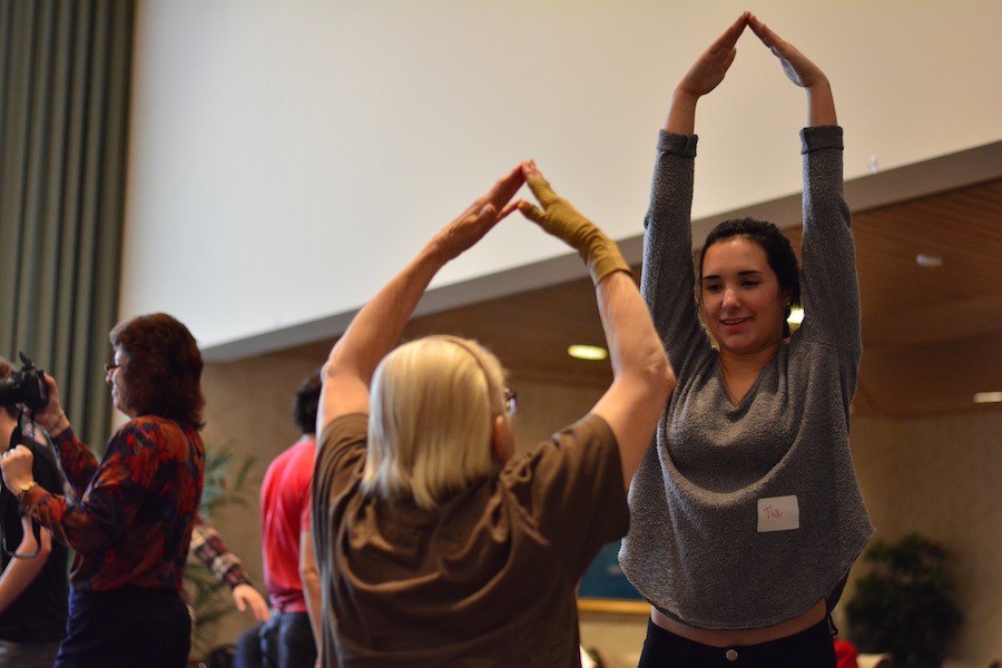 Sophomore Tia Sposito shows her friend from the Jones-Harrison Senior Livng Center specific motions for the dance.  