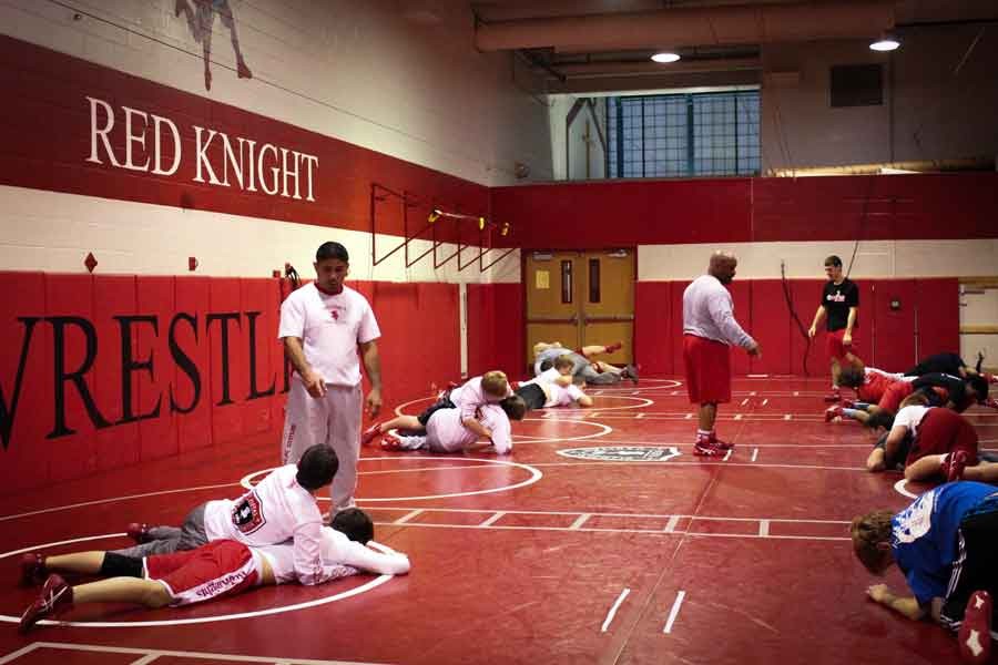 Wrestlers practice earlier in the season, which helped them to send three wrestlers to State.