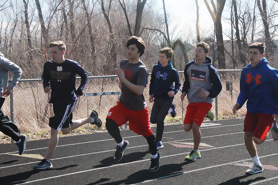 A group of runners participates in a time trial, the 600-meter run, at a recent practice.