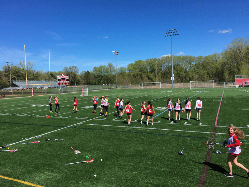 Girls' lacrosse walks out to the field for a practice.