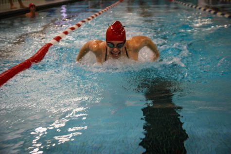 A swimmer works on her butterfly during one of 5-6 required practices each week.