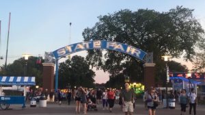 Minnesotans traverse the Midway at dusk at this years State Fair, eager to try out new food. 