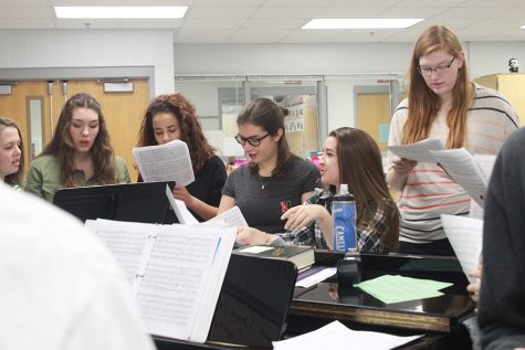 Soprano and alto singers of the Red Knotes rehearse before school with directors Nancy Stockhaus and Adam Petroski. The Red Knotes will be going on a retreat in November to get to know each other better and work better as a choir.