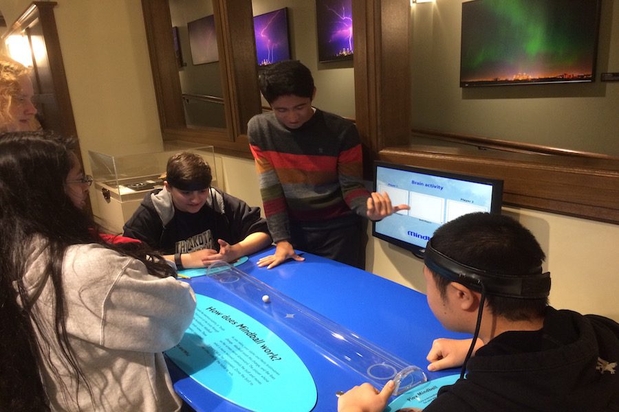 Seniors Alex Aldes and Sam Luo play Mind Ball, a game where the students compete to see who can have a more relaxed mind. This was one of the more popular interactive exhibits that students explored during the field trip.
