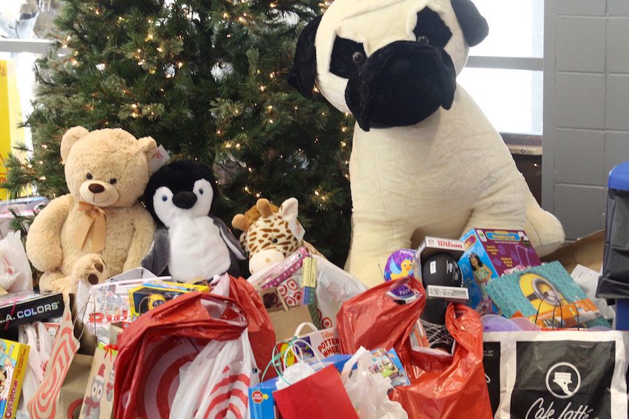 The+toys+collected+for+the+Common+Basket+were+placed+underneath+a+Christmas+tree+in+the+library.