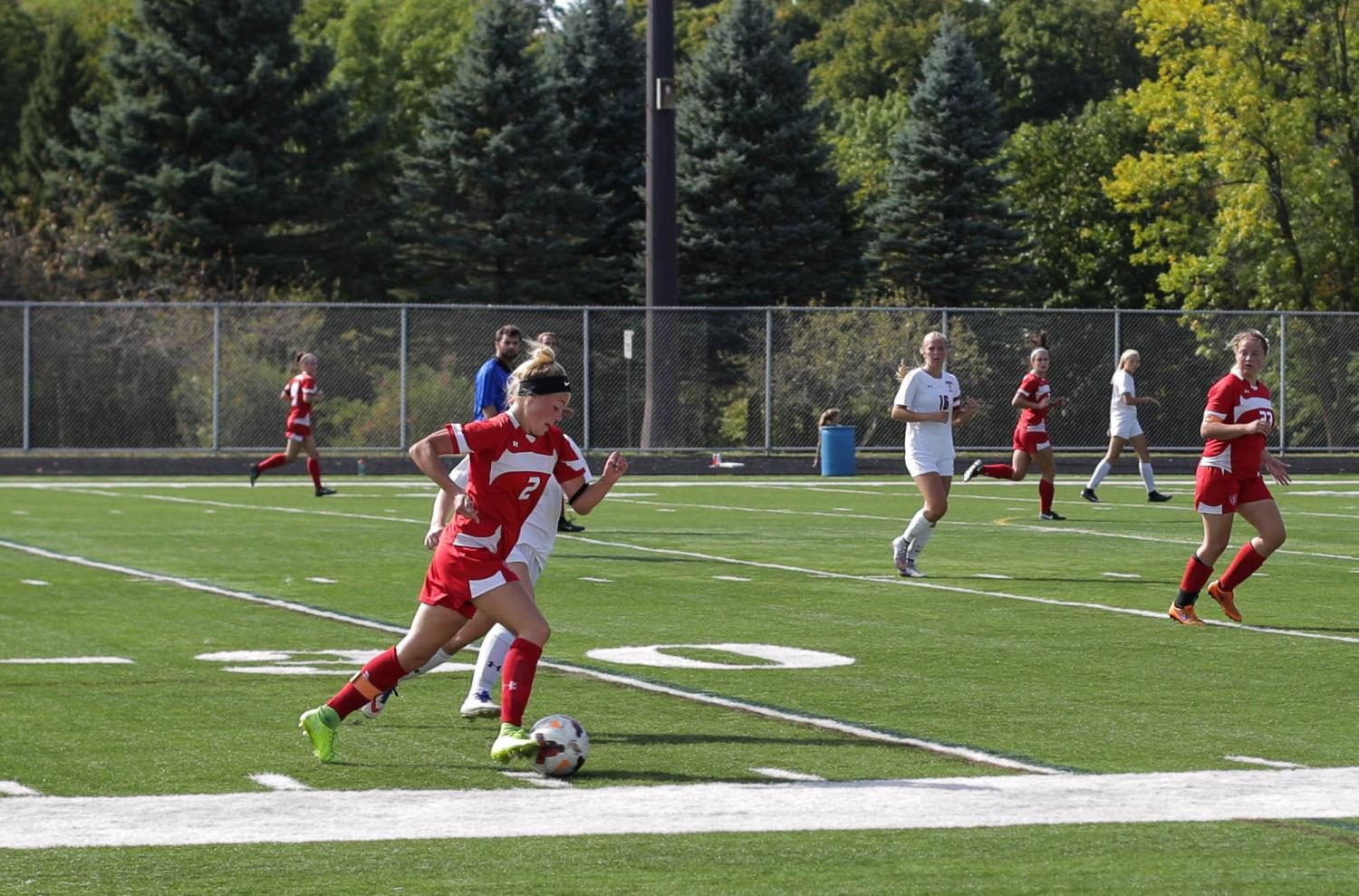 Senior captain Maddie Stoks dribbles past a defender in a recent game.