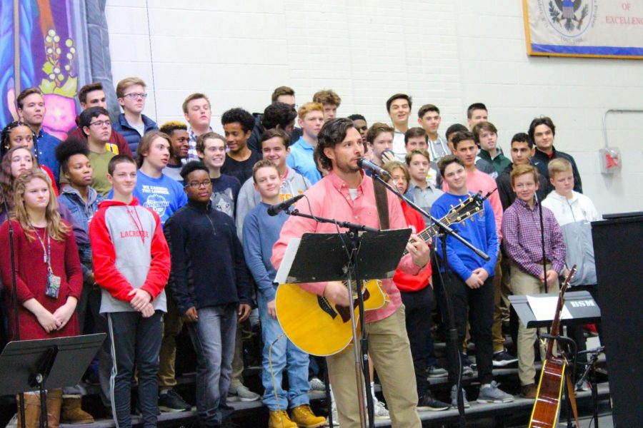 Wellness+and+gym+teacher+Mr.+Casey+Hanson+performs+a+song+at+the+prayer+service.