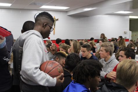 There are enough boys in the freshmen class that some, like Isadore Hall, choose to stand during lunch to be by their friends. 
