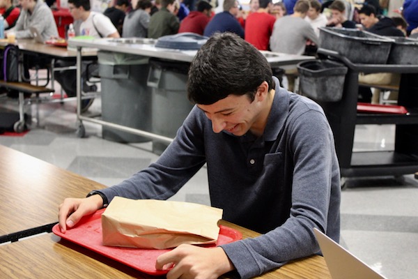 Brady Solomon sits at different lunch tables