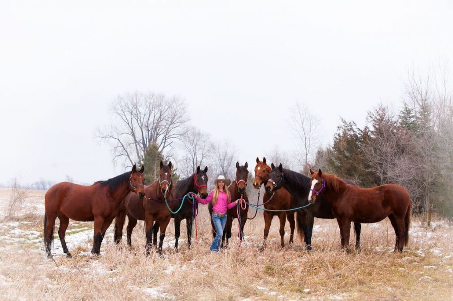 Junior Jillian Zaun poses with her horses.