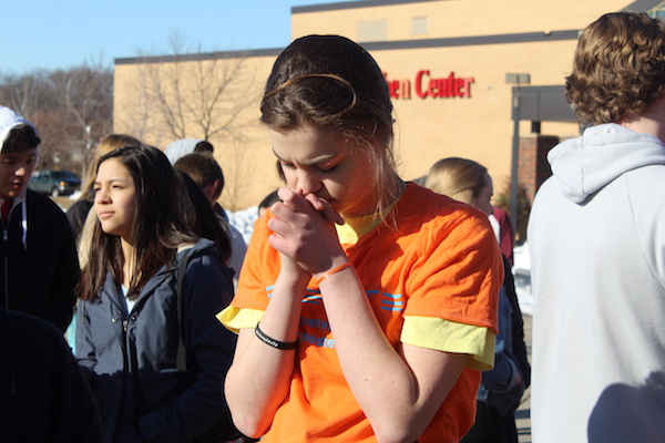 A huge part of the walkout was remembering the students who were lost in the Parkland shooting. Sophomore Julia Hoover prays and grieves the Florida victims. 