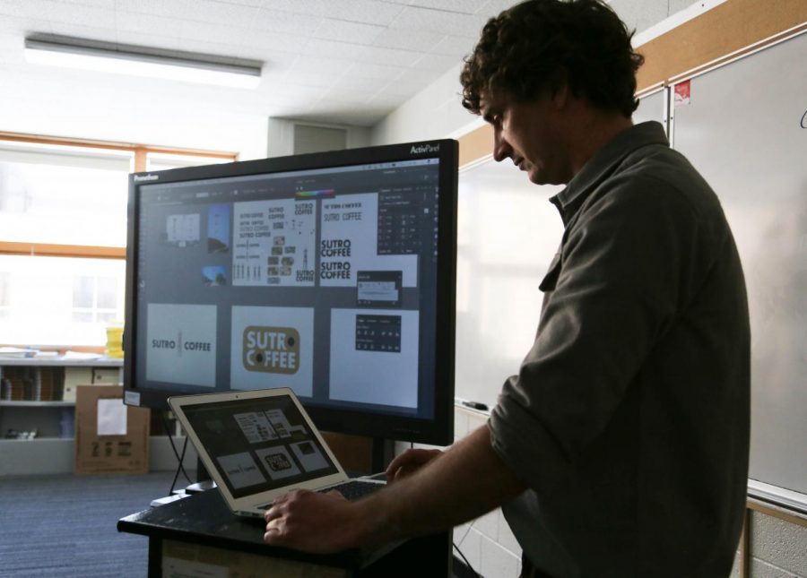 Teacher Zach Zimney uses technology often to teach his graphic design classes.
