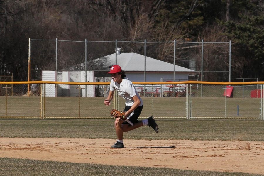 Junior Harrison Shibley takes in field grounders in preparation for the season