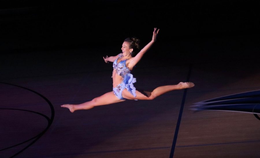 Dance Team Captain Molly Segner leaps around the floor in an exhilarating solo. 