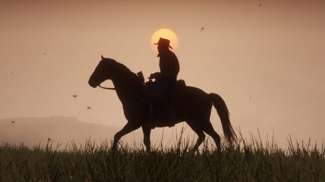A cowboy riding his horse during the sunset