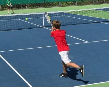 Junior Harry Madden focuses on his form during his singles match. 