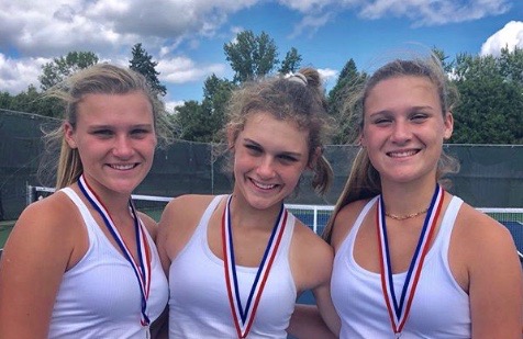 Brooke, Courtney, and Lauren Kallas celebrate the end of their tennis match.