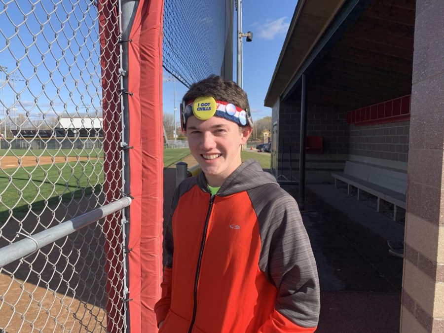 Junior cross country runner Ryan Kraemer poses with his pin-decorated sweatband for Fun Hat Friday 
