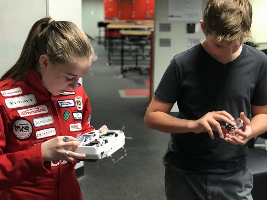 Junior Claire Larson and freshman Tommy Medina learn to control their drones.