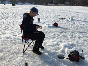 Ice Fishing: After drilling a hole and getting set up, its all about the waiting.