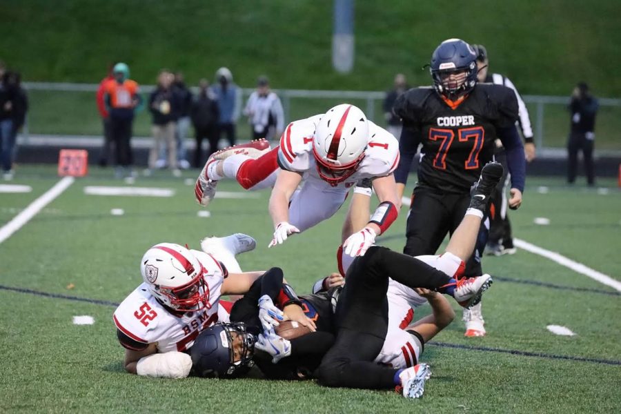 Senior captain George Wolfe dives over a tackle made by co-captain Nick Marinaro during the 2019 season. The team looks forward to making new memories together on the field this fall.