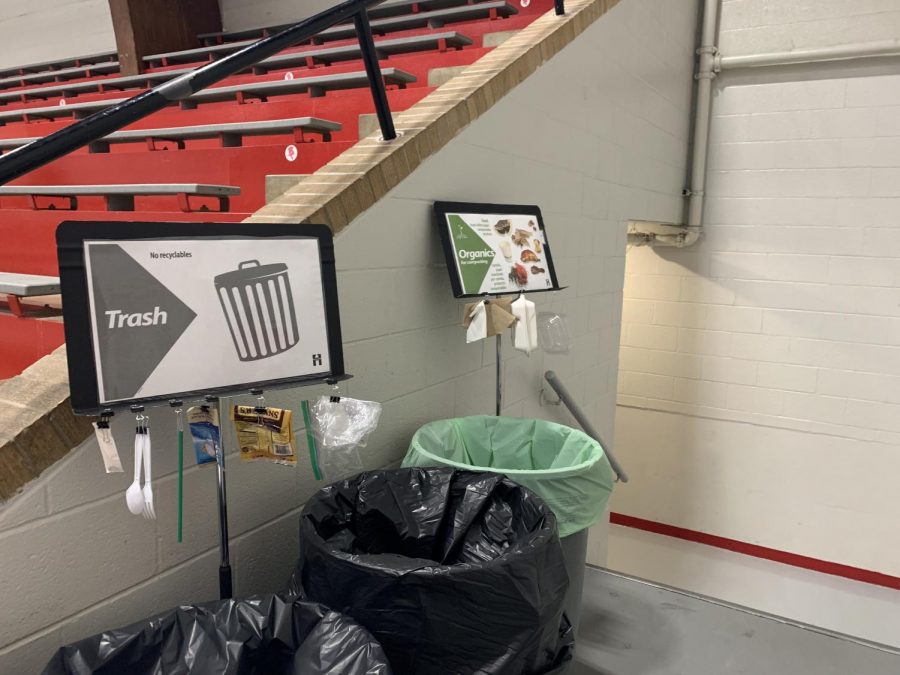 Posters are mounted above the trash and organics bins to aid students in sorting their waste.