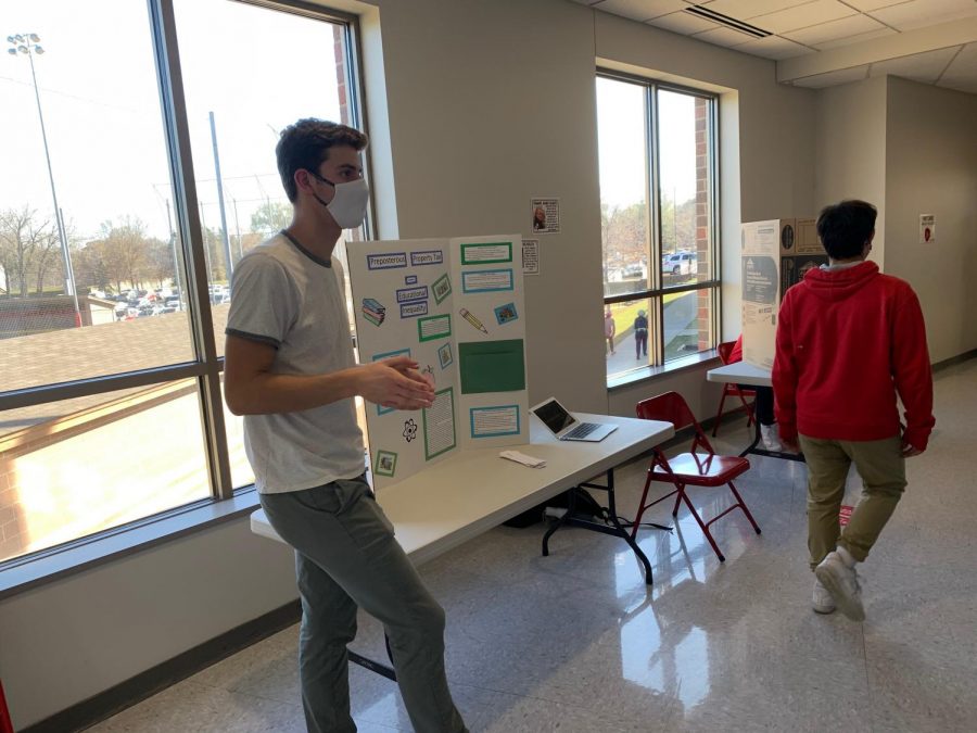 Senior Theo Pohlen presents his Justice Fair project on Education Inequality.