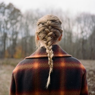 The cover photo for the album features Swift looking out into a forest, photographed from behind. 