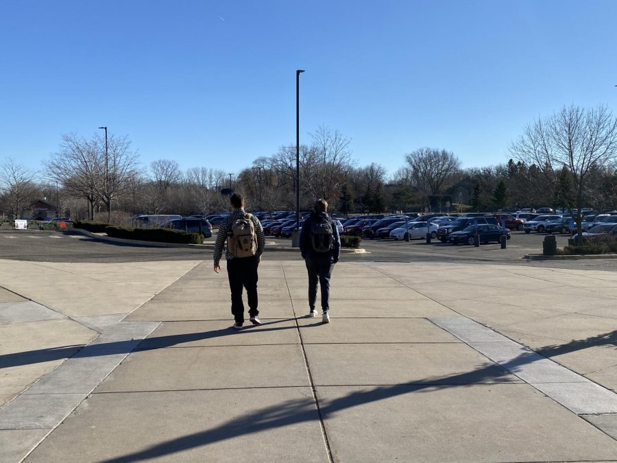 Seniors Nick Marinaro (left) and Josh Sullivan (right) walk to their cars in the parking lot.