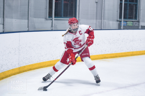 Senior Defensemen Abigail Hancock skates around the net looking for a pass.