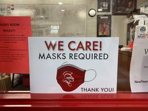 A sign outside of Athletic Director Jerry Pettingers office reminds students and visitors that masks are required at all times.