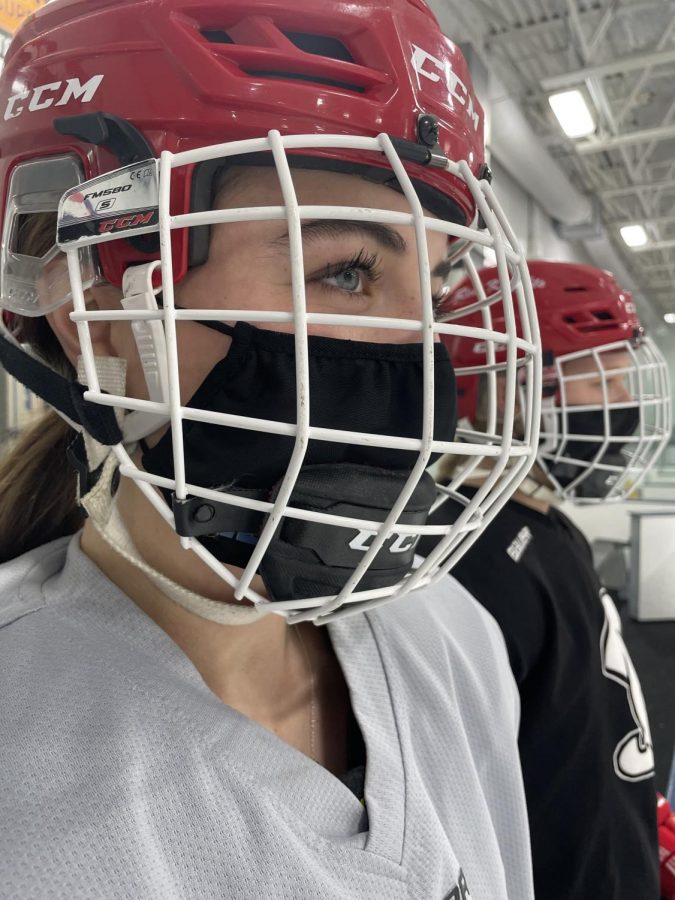 BSM girls varsity hockey players stay safe by following COVID guidelines and wearing masks to practice.