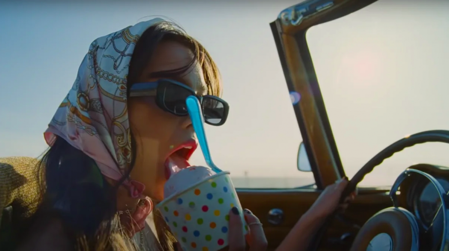 Olivia Rodrigo eats strawberry ice cream in her official music video for deja vu.